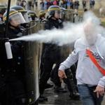 A demonstrator was hit with pepper spray while marching against the labor law in Paris on Thursday.