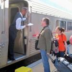A Southwest Chief sleeping car attendant, Anthony Buck Jr., checks a ticket in Albuquerque. 