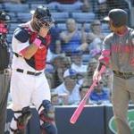 Arizona Diamondbacks' Jean Segura (2) argues a strikeout with home plate umpire Rob Drake, left, as Atlanta Braves catcher A.J. Pierzynski stands between them during the tenth inning of a baseball game, Sunday, May 8, 2016, in Atlanta. (AP Photo/John Amis)