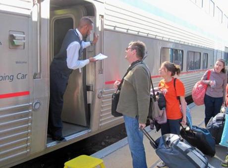 A Southwest Chief sleeping car attendant, Anthony Buck Jr., checks a ticket in Albuquerque. 
