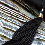 Higher education conceptual image with graduation cap and tassel on american currency. Macro with extremely shallow dof.; Shutterstock ID 44454148; PO: OPED
