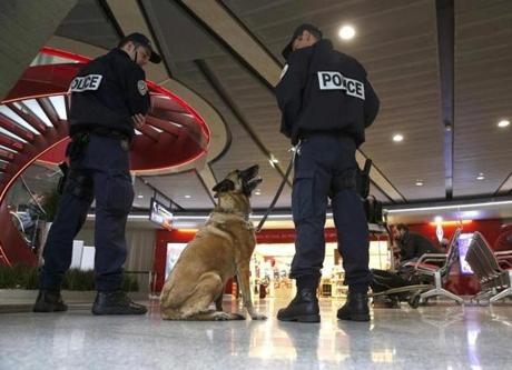 A police canine patrol stood guard at Charles de Gaulle airport.
