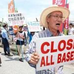 Protesters shouted slogans outside a US air base in Kadena, Okinawa, Friday.