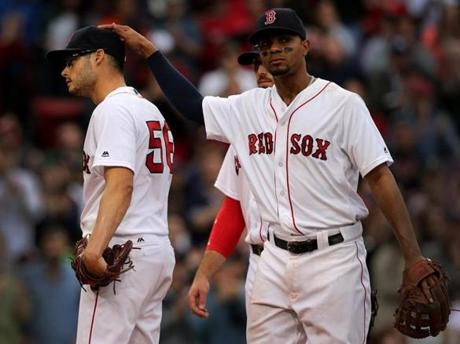 Joe Kelly (left) received an appreciative pat on the head from Xander Bogaerts after the Indians got their first hit of the game in the seventh inning.
