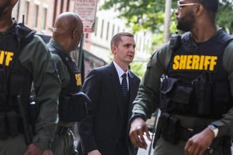 Baltimore police officer Edward Nero (center) entered the court house on Monday.
