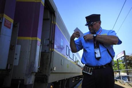 Brian Ernst, a conductor on the Newburyport/Rockport Line, waited for passengers to board the train at the Swampscott commuter rail station Monday.
