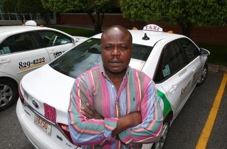 Celestin Couyoute is one of many Boston-area taxi medallion owners who are feeling the pressure of declining income and high loan repayment costs.
