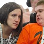 Jenn McNary speaks with Austin Leclaire, who suffers from Duchenne Muscular Dystrophy during hearings over conflicting interpretations of findings from Sarepta's clinical trial of an experimental drug to treat Duchenne muscular dystrophy. Duchenne muscular dystrophy is a rare disease that strikes one in 3500 boys who typically don't survive into their 30's. Sarepta's drug is meant to treat a specific gene mutation. (John Boal for The Boston Globe)