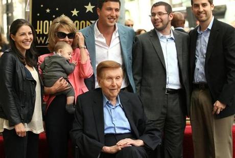 Sumner Redstone, bottom center, surrounded by family including his granddaughter Kim, left, daughter Shari (in pink) and grandson Tyler Korff.
