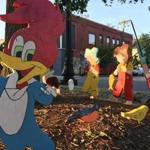 A Woody Woodpecker ornament and other wood cutouts have appeared on a traffic island in Somerville.