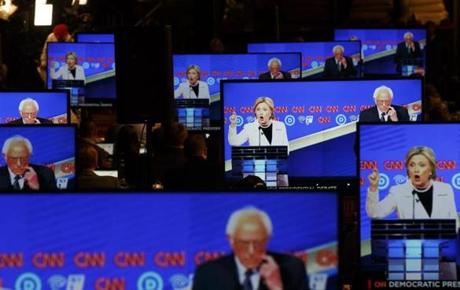 epa05259452 Democratic presidential candidates Secretary Hillary Clinton and Sen. Bernie Sanders are seen on television screens in the press room during a CNN-sponsored debate between the two candidates at the Brooklyn Navy Yard in Brooklyn, New York, USA, on 14 April 2016. New York will hold its primary election on 19 April 2016. EPA/JUSTIN LANE
