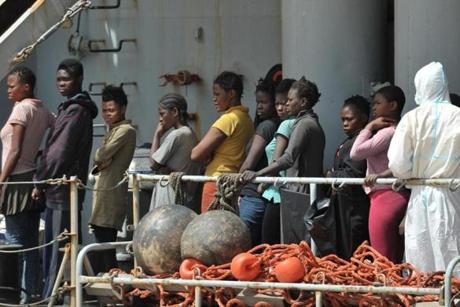 Women rescued at sea arrive aboard the Italian Navy ship 