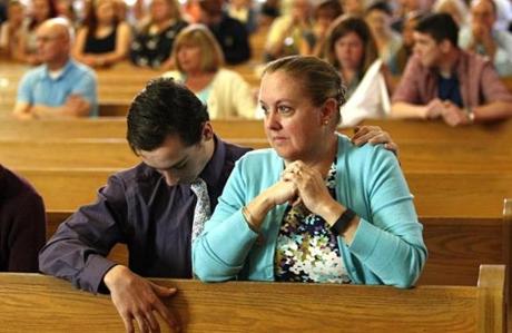 Scituate, MA - 05/29/16 - Christine Arnold(R) and Scott Arnold pray during the final service at St Francis X. Cabrini church in Scituate, MA, May 29, 2016. After 4,233 consecutive days in vigil, the parishioners of St. Frances X. Cabrini closed their spiritual home.(Keith Bedford/GlobeStaff)
