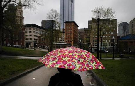 A woman walked through the morning rain on Boston Common earlier this month.
