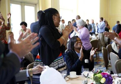 Boston, MA - 5/31/2016 - Natalia Phillip, Valedictorian of New Mission High School, (R) laughs as her sister, Janel Alfred, (L) applauds her and her fellow valedictorians during a luncheon at the Boston Harbor Hotel in Boston, MA May 31, 2016. Jessica Rinaldi/Globe Staff Topic: 01valedictorian Reporter: 
