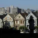 A woman looked toward the ?Painted Ladies,? a row of historic Victorian homes, with the San Francisco skyline in the background. 