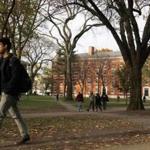 A student walks through Harvard Yard at Harvard University in Cambridge, Massachusetts, in this file photo taken November 16, 2012. Harvard University said on its website on Monday that it had received an 