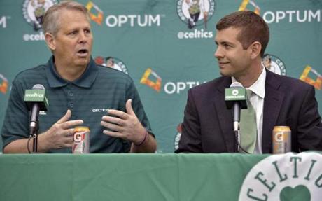 Boston Celtics general manager Danny Ainge, left, speaks alongside new head coach Brad Stevens, right, during a news conference where Stevens was introduced Friday, July 5, 2013, at the NBA basketball team's training facility in Waltham, Mass. Stevens twice led the Butler Bulldogs to the NCAA title game. He replaces Doc Rivers, who was traded to the Los Angeles Clippers. (AP Photo/Josh Reynolds)
