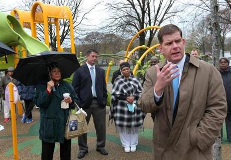 BOSTON, MA - 5/05/2016: City of Boston Mayor Marty Walsh interacting with members of the black community who were at at Almont Park in Mattaphan. Annie Kinkade is at back left with green coat and umbrella.(David L Ryan/Globe Staff Photo) SECTION: METRO TOPIC 09Walsh
