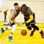 Golden State Warriors guard Stephen Curry (left) and Cleveland Cavaliers forward LeBron James scramble for a loose ball during the second quarter of game 1 of the NBA Finals on June 2, 2016 in Oakland, California. / AFP PHOTO / Beck DiefenbachBECK DIEFENBACH/AFP/Getty Images