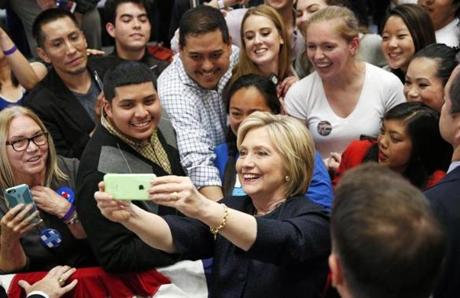 Democratic presidential candidate Hillary Clinton takes a selfie with supporters at a rally, Thursday, May 26, 2016, in San Francisco. (AP Photo/John Locher)
