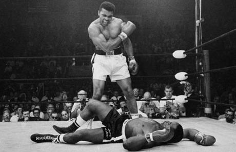 Muhammad Ali stood over Sonny Liston after knocking him down during their bout in Lewiston, Maine.
