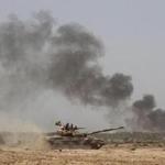 Iraqi government forces advance towards the centre of Saqlawiyah, north west of Fallujah, during an operation to regain control of the area from the Islamic State on Saturday.