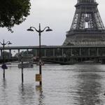 Road signs emerge on the banks of the Seine River next to the Bir Hakeim bridge and the Eiffel Tower during floods in Paris on Saturday.