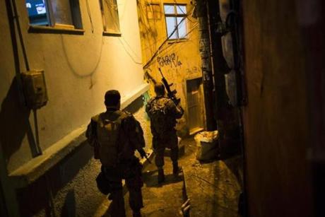 Police officers walk in an alley during a police operation at Rocinha slum in Rio de Janeiro, Brazil on Friday.
