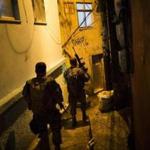Police officers walk in an alley during a police operation at Rocinha slum in Rio de Janeiro, Brazil on Friday.