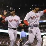 Mookie Betts (right) and Marco Hernandez passed Travis Shaw after they scored in the 10th inning.