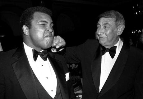 FILE - In this April 13, 1981, file photo, sportscaster Howard Cosell, right, is pictured laying one on the chin of former world heavyweight boxing champ Muhammad Ali during a dinner in New York. Ali, the magnificent heavyweight champion whose fast fists and irrepressible personality transcended sports and captivated the world, has died according to a statement released by his family Friday, June 3, 2016. He was 74. (AP Photo/Richard Drew, File)
