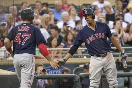 Jun 10, 2016; Minneapolis, MN, USA; Boston Red Sox third baseman Travis Shaw (47) celebrates with shortstop Xander Bogaerts (2) after scoring a run in the sixth inning against the Minnesota Twins at Target Field. Mandatory Credit: Jesse Johnson-USA TODAY Sports
