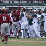 A brawl breaks out after Miami's Edgar Michelangeli hit a grand slam in the seventh inning of NCAA college baseball tournament super regional game against Boston College, Sunday, June 12, 2016, in Coral Gables, Fla. (AP Photo/Wilfredo Lee)