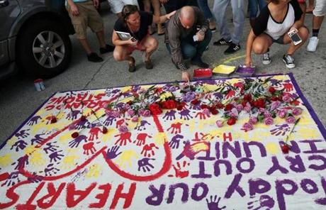 People put their hand prints on a makeshift memorial near the scene of the attack in Orlando.
