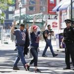 An officer guided volunteers across the street as Boston police and the Department of Homeland Security took part in a counterterrorism exercise at Fenway Park on Sunday. 