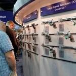 Gun enthusiasts looked over Smith & Wesson guns at the National Rifle Association's (NRA) annual meetings and exhibits show in Louisville. 