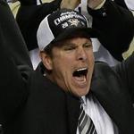 Penguins coach Mike Sullivan hoisted the Stanley Cup after his team clinched the title.