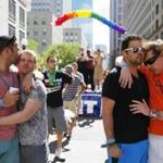 Couples embraced during a moment of silence for the Orlando shooting victims Sunday afternoon at a Boston Pride party.