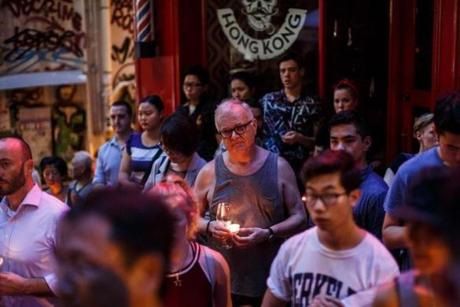 People hold candles as they share a minute of silence during a vigil for the victims of the Orlando shooting in Florida, in Hong Kong on June 13.
