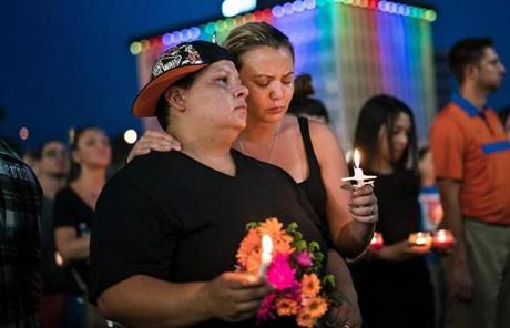 TOPSHOT - Nicole Edwards and her wife Kellie Edwards observe a moment of silence during a vigil outside the Dr. Phillips Center for the Performing Arts for the mass shooting victims at the Pulse nightclub June 13, 2016 in Orlando, Florida. The American gunman who launched a murderous assault on a gay nightclub in Orlando was radicalized by Islamist propaganda, officials said Monday, as they grappled with the worst terror attack on US soil since 9/11. / AFP PHOTO / Brendan SmialowskiBRENDAN SMIALOWSKI/AFP/Getty Images

