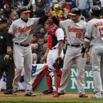 Boston, MA - 4/11/2016 - (L-R) Baltimore Orioles Mark Trumbo celebrates his three run home run with teammates Chris Davis, Manny Machado during the third inning of the Red Sox Home Opener at Fenway Park in Boston, MA April 11, 2016. Jessica Rinaldi/Globe Staff Topic: RedSox-Orioles Reporter: 
