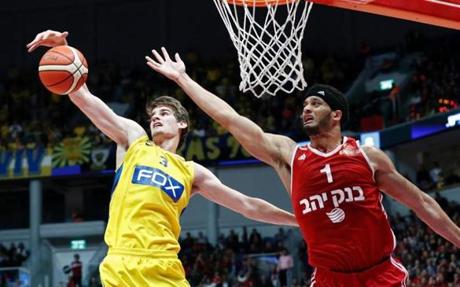 Maccabi Tel Aviv's Croatian player Dragen Bender (L) fights for the ball against Hapoel Jerusalem's US player Josh Duncan during a Winner League match between Maccabi Tel Aviv and Hapoel Jerusalem at the Pais Arena in Jerusalem on March 21, 2016. Dragan Bender's name is not yet well known beyond hardcore basketball fans, but that may soon change. Bender, currently playing for Israeli club Maccabi Tel Aviv, is expected to be highly sought after by US professional basketball teams in the coming months. / AFP PHOTO / THOMAS COEXTHOMAS COEX/AFP/Getty Images
