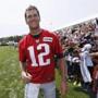 New England Patriots quarterback Tom Brady walks down the line of fans signing autographs during an NFL football training camp in Foxborough, Mass., Saturday, Aug. 1, 2015. (AP Photo/Michael Dwyer)