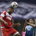 New England Revolution's Andrew Farrell, left, gets his head on the ball above Vancouver Whitecaps' Matias Laba during the first half of an MLS soccer game Saturday, June 18, 2016, in Vancouver, British Columbia. (Darryl Dyck/The Canadian Press via AP)