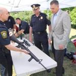 Watertown Police Lieutenant Daniel Unsworth showed the AR-15 assault style gun to Middlesex Sheriff Peter J. Koutoujian (right) and Watertown Police Chief Michael Lawn (center). 