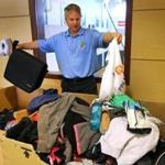Manchester- 6/17/2016 Manchester Essex Middle and High School has lost and found bins full with stuff from students through the school year. Assistant Principal Paul Murphy examines a few items. Boston Globe staff photo by John Tlumacki(metro)