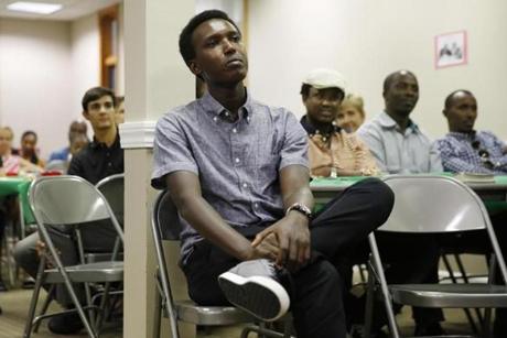 Needham, Massachusetts -- 7/16/2015-- Unable to go home for his father's funeral in Burundi, Alex listens to a sermon during a Memorial Service for his father at at Good Shepard Christian Fellowship in Needham, Massachusetts September 19, 2015 just four months after celebrating Leo's 5th birthday in the same location. Jessica Rinaldi/Globe Staff Topic: 062616alexleofollow Reporter: Scott Helman
