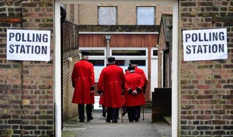 TOPSHOT - Chelsea pensioners are ushered into a polling station to cast their ballot papers at the Royal Hospital in Chelsea, west London on June 23, 2016, as Britain holds a referendum to vote on whether to remain in, or to leave the European Union (EU). Millions of Britons began voting Thursday in a bitterly-fought, knife-edge referendum that could tear up the island nation's EU membership and spark the greatest emergency of the bloc's 60-year history. / AFP PHOTO / LEON NEALLEON NEAL/AFP/Getty Images

