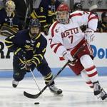 Boston MA 1/29/16 Boston University freshman Charlie McAvoy skates with the puck in front of Merrimack College Marc Biega during third period action at Agganis Arena on Friday January 29, 2016. (Matthew J. Lee/Globe staff) Topic: Reporter: 